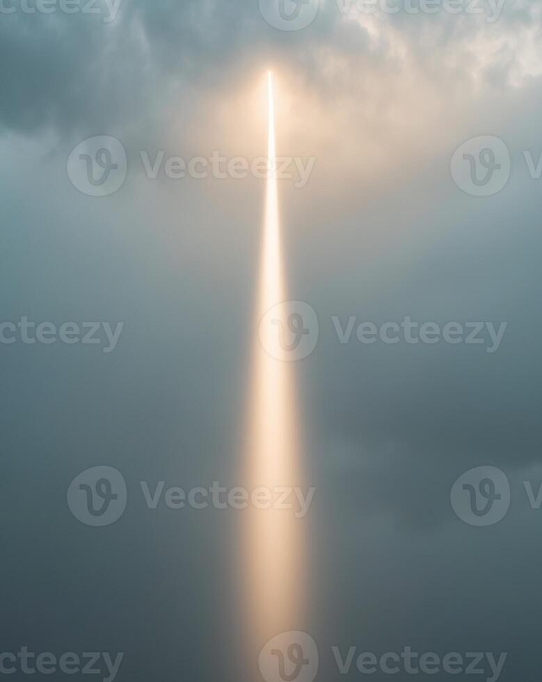A single beam of light shining through the mist and cloud photo
