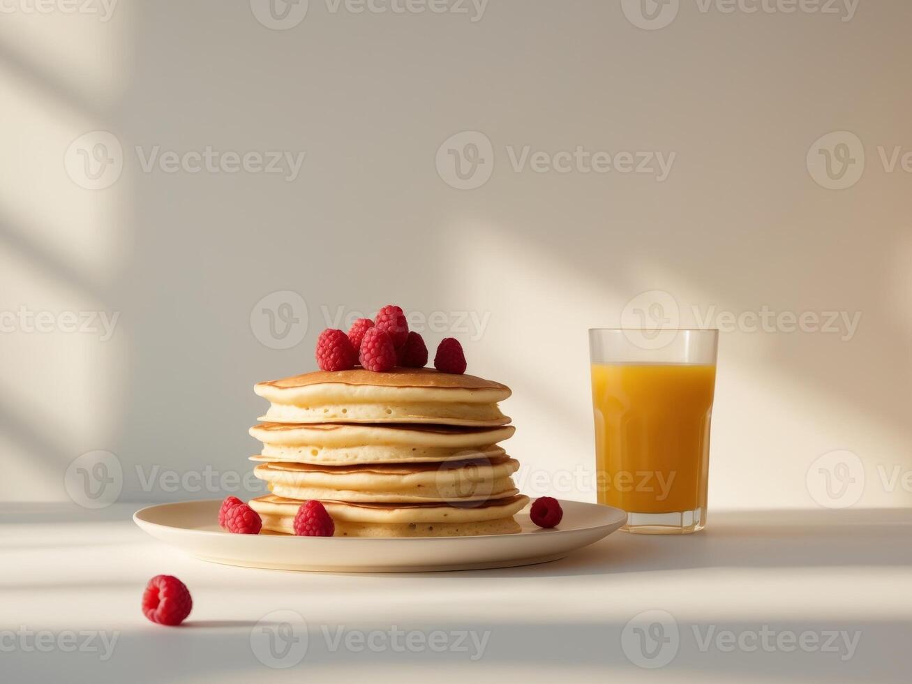 A stack of pancakes with raspberries on top of them photo