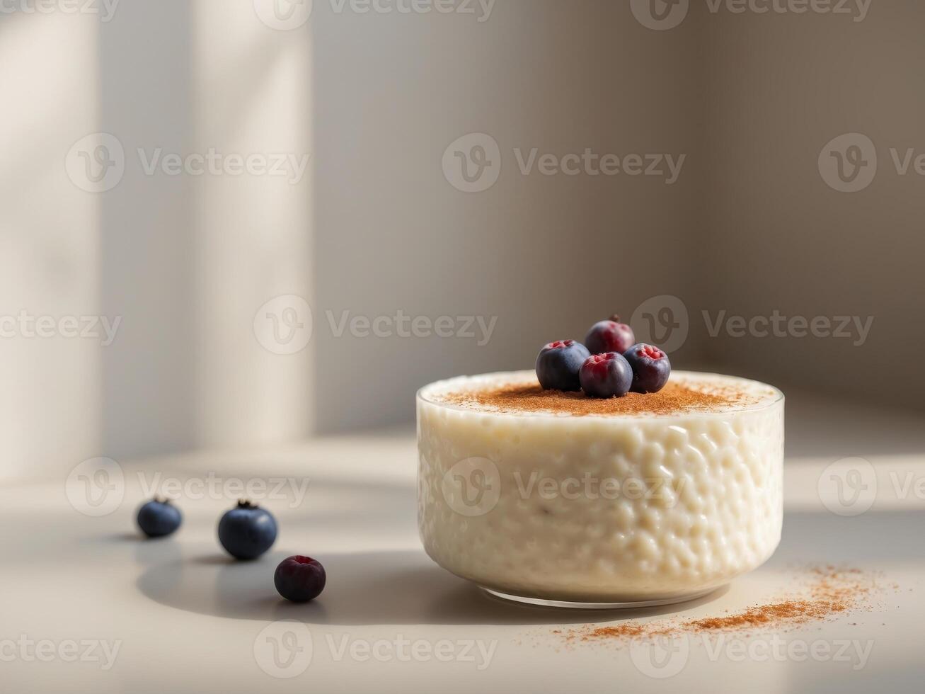 A bowl of rice pudding with blueberries on top photo