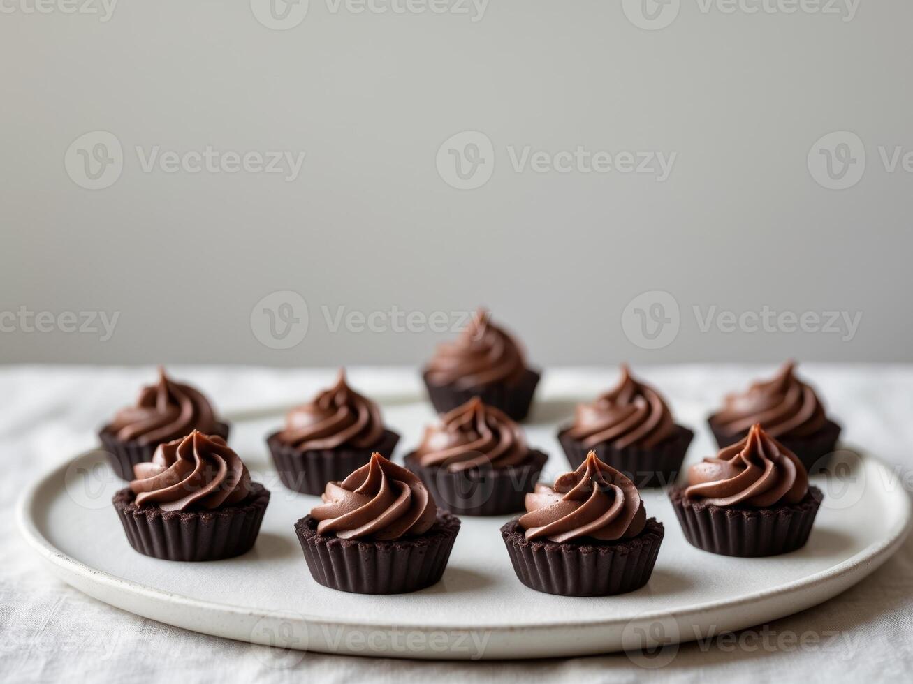 Group of Mini Chocolate Tarts with Chocolate Frosting photo