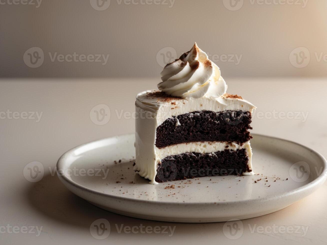 A piece of cake on a plate with whipped cream photo