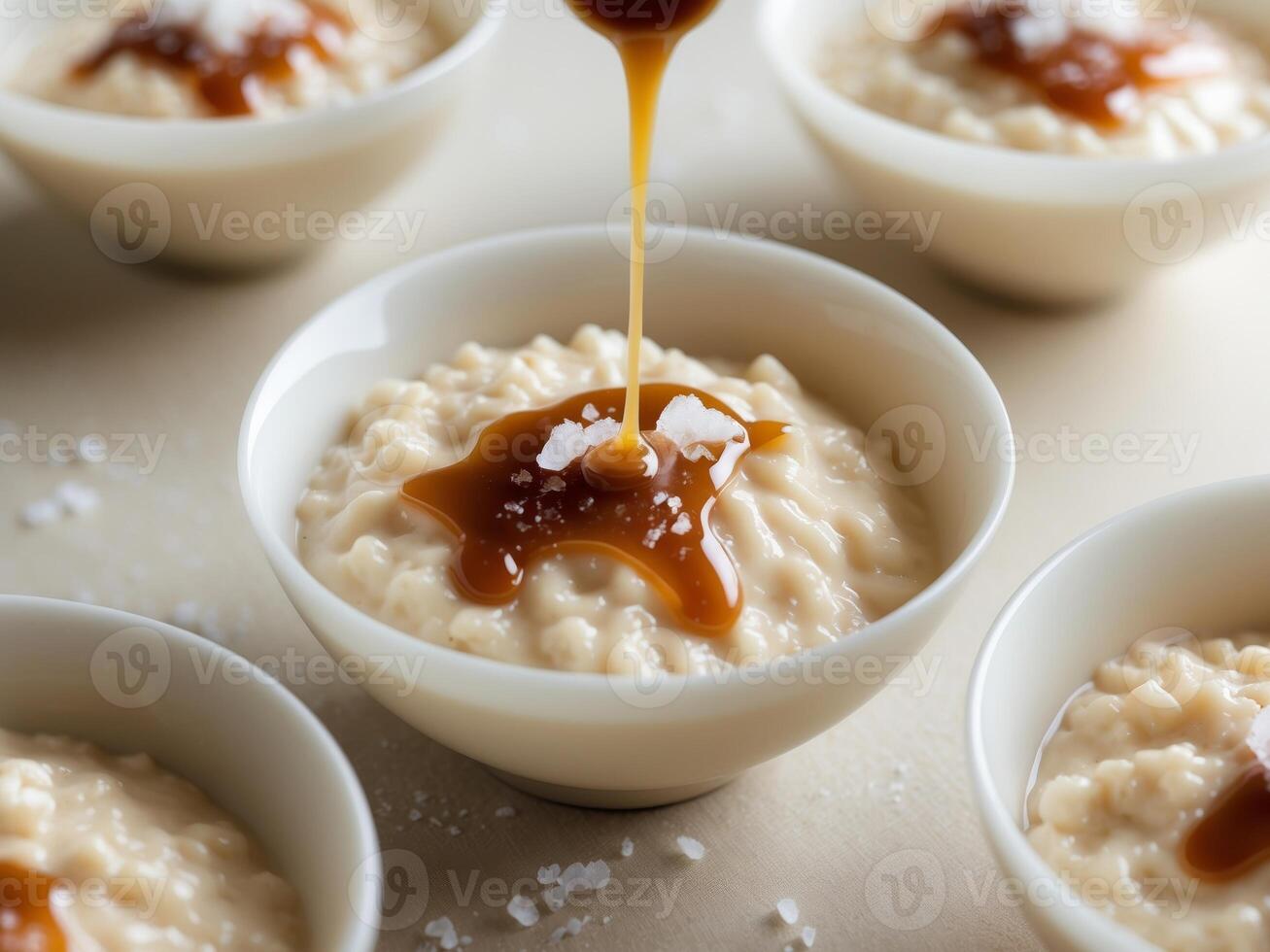 A bowl of oatmeal with caramel sauce being poured over it photo