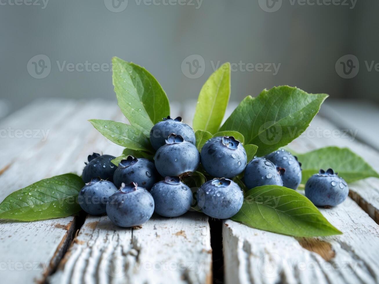 Fresh Blueberries with Green Leaves on Rustic White Wooden Surface for Healthy Food Concept photo