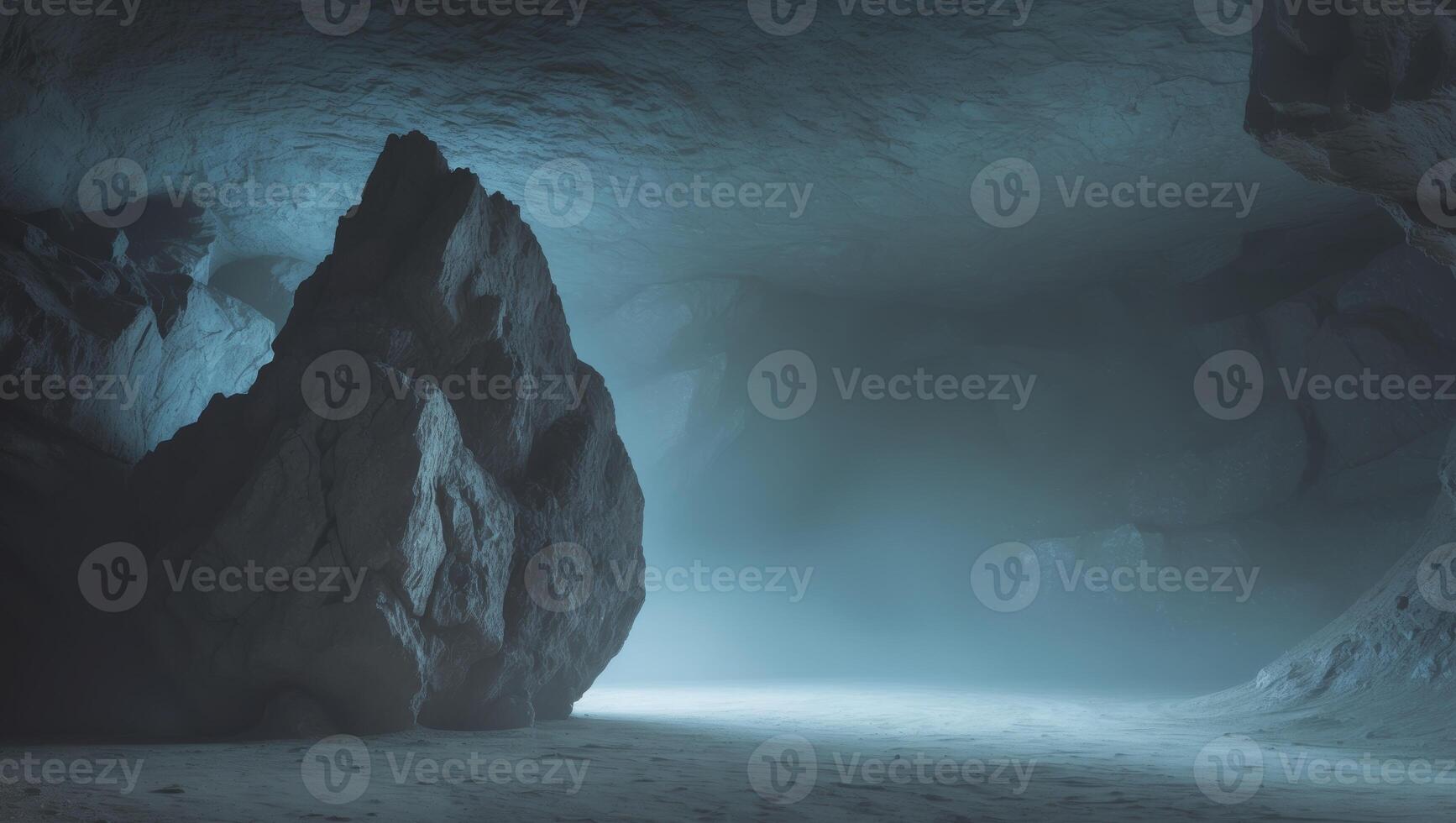 A large rock sits in the center of a dark and mysterious cave photo