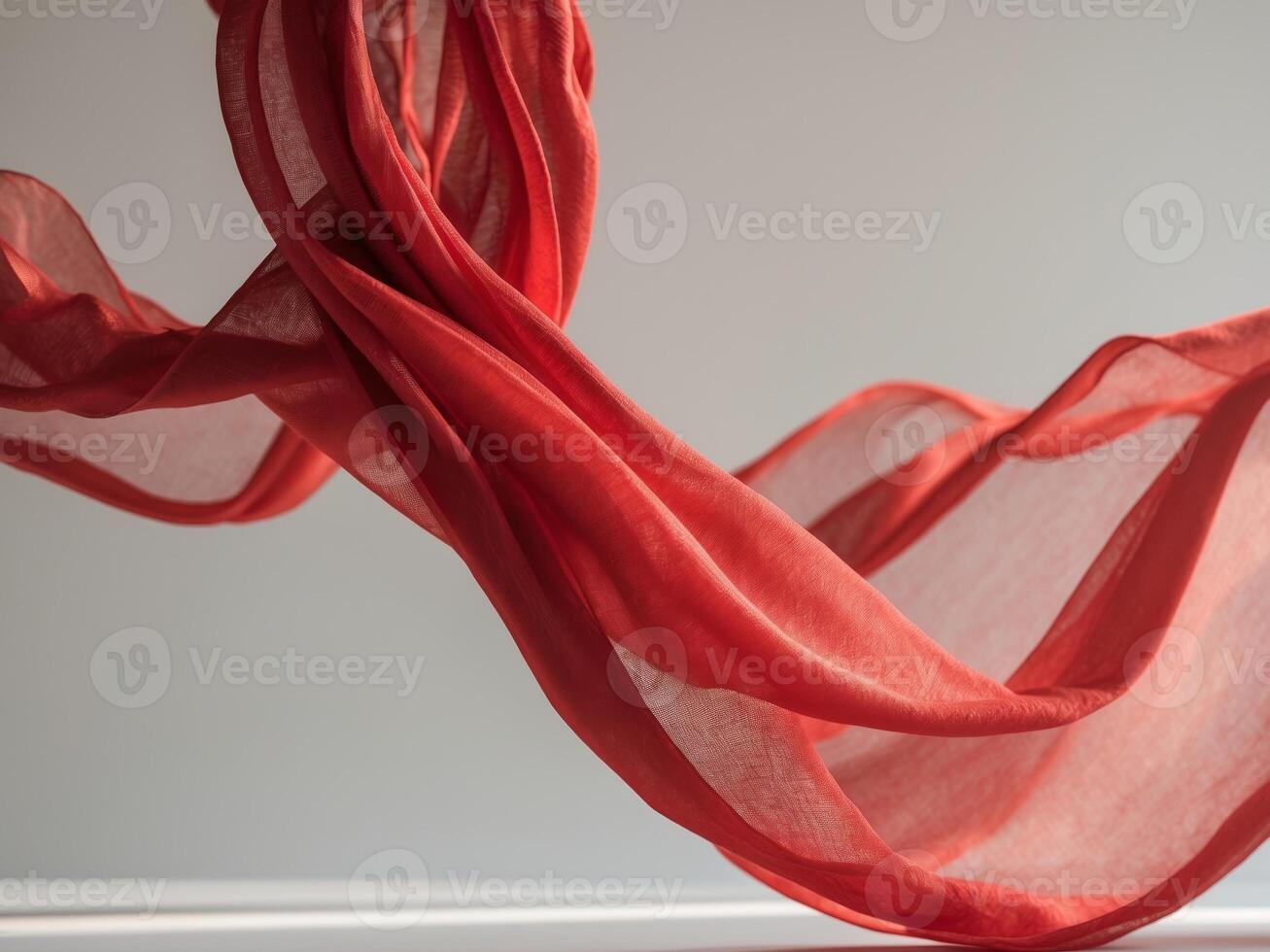 A red silk scarf is flying in the air photo