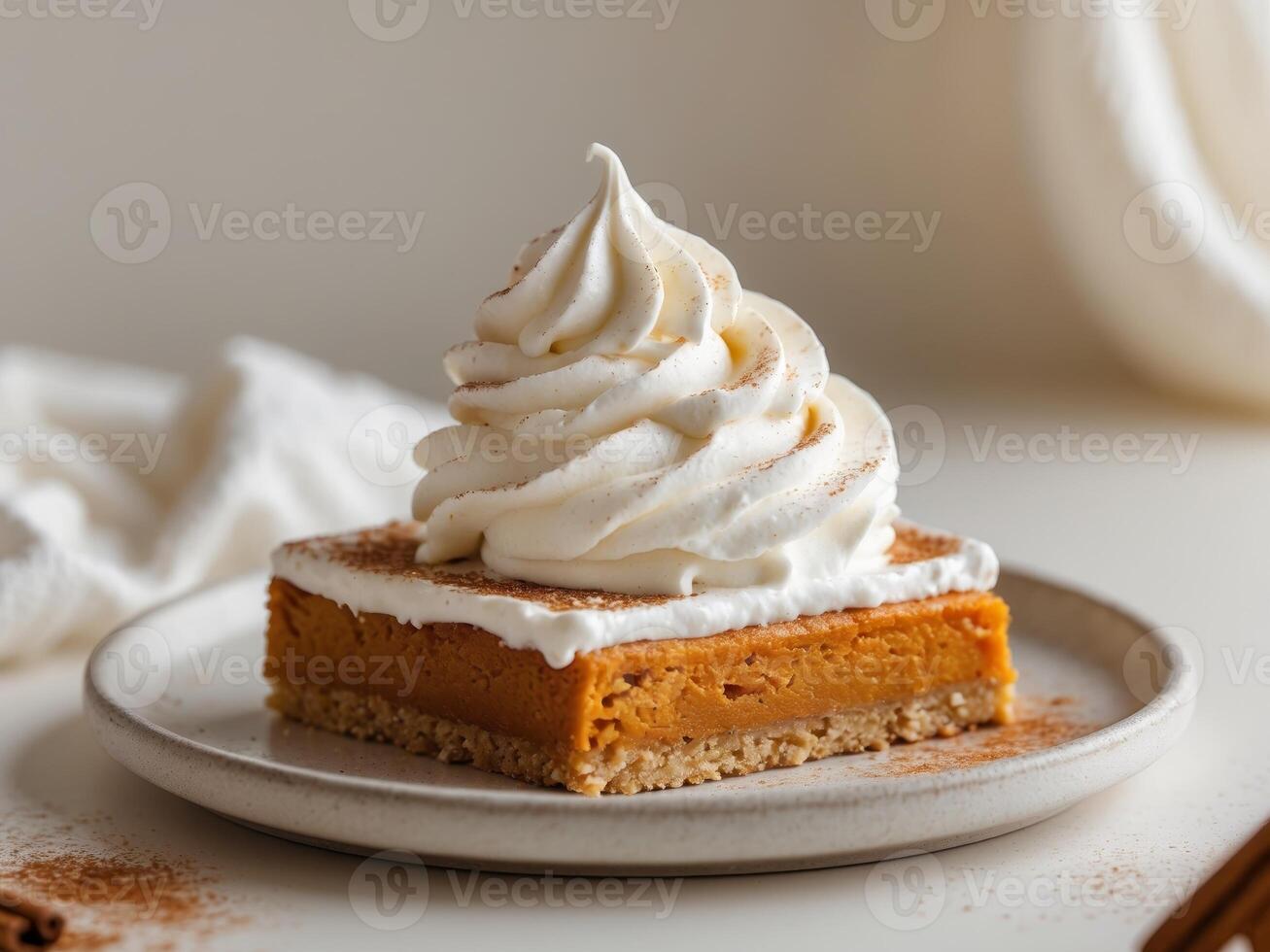 A slice of pumpkin pie on a plate with whipped cream photo