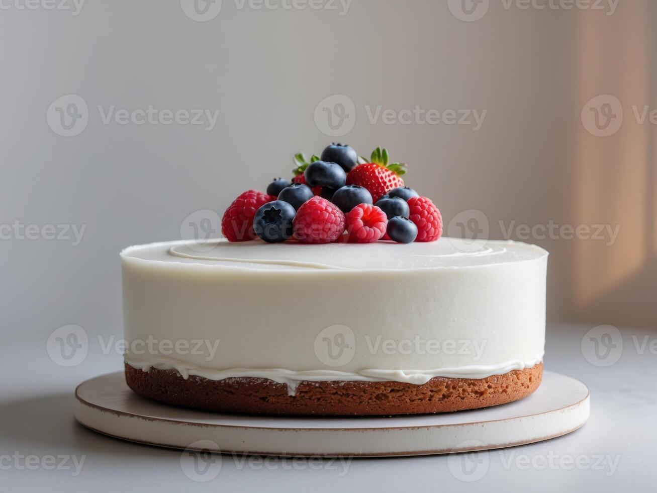 A white cake with berries on top photo