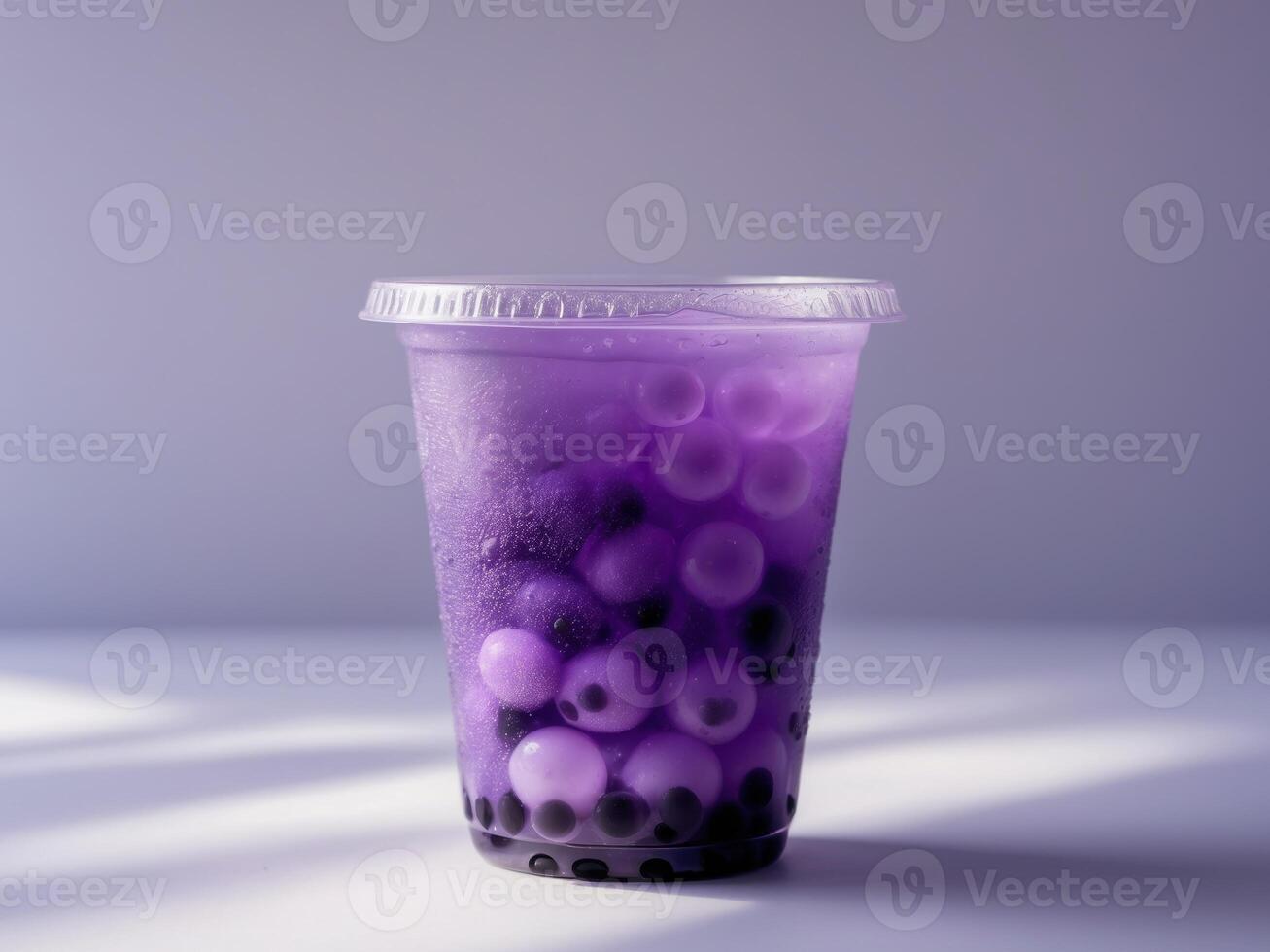 A purple bubble tea with blackberries in it photo