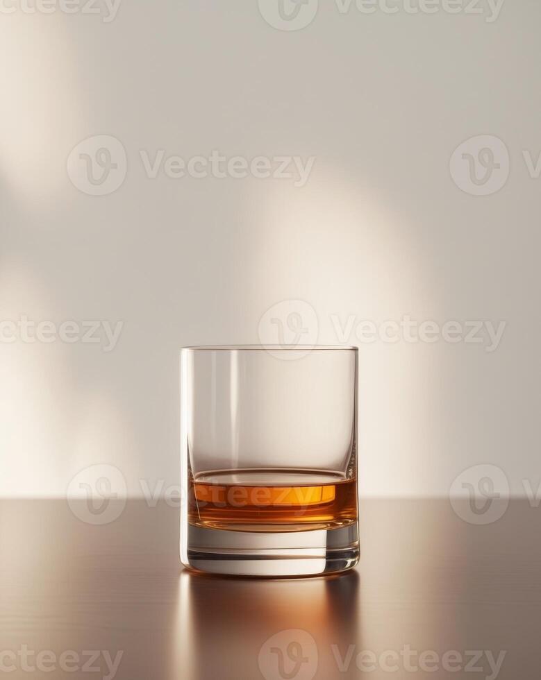 there is a glass of whiskey sitting on a table photo