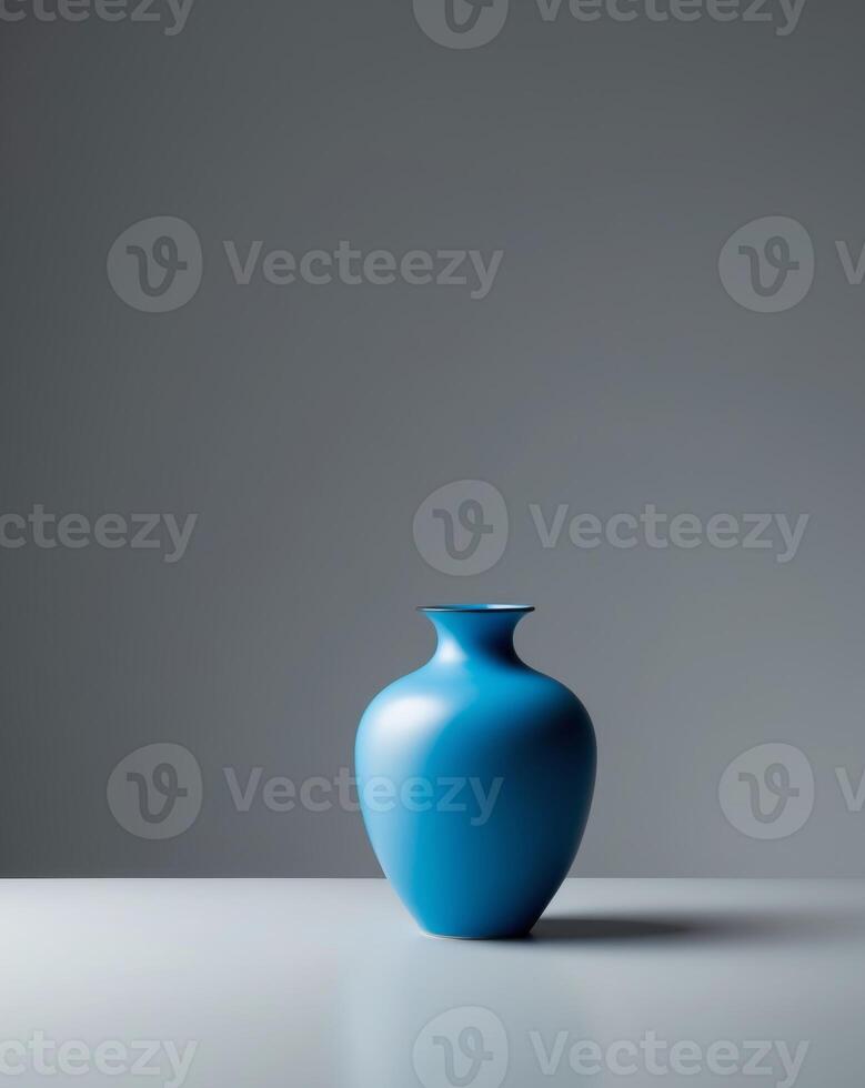 A blue vase sitting on a table in front of a gray wall photo