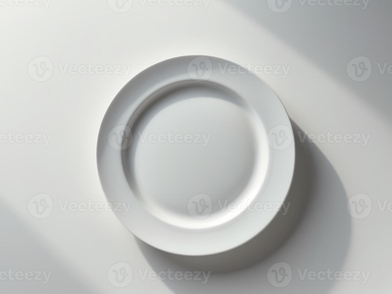 A white plate on a table with shadow photo