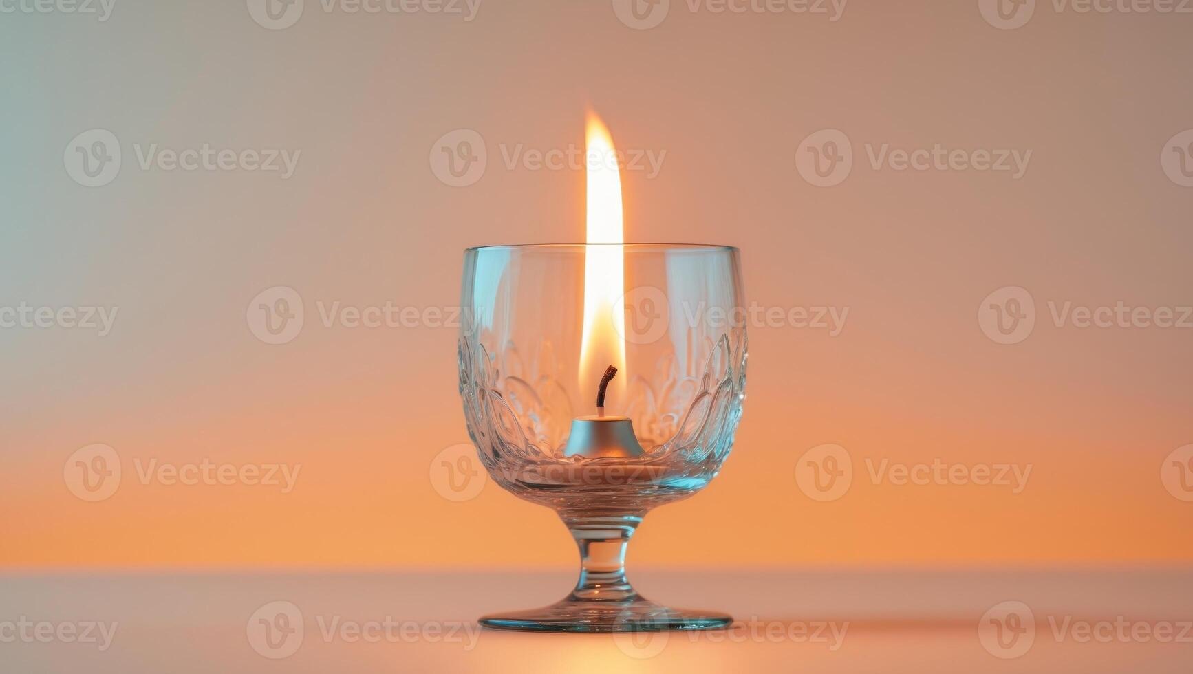 Candle in a glass with a yellow background photo