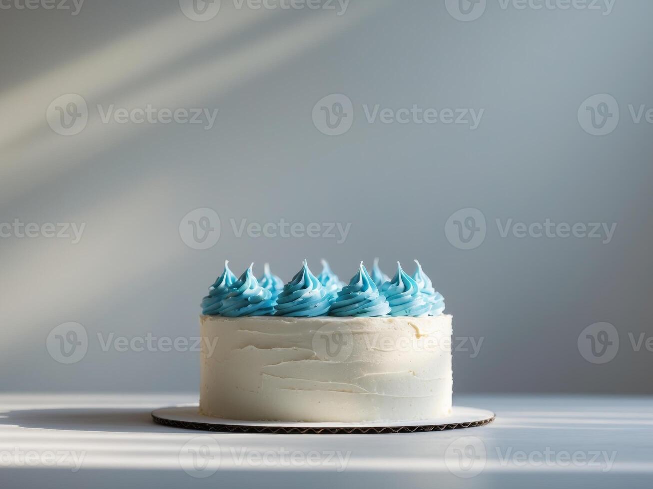A white cake with blue frosting on top photo