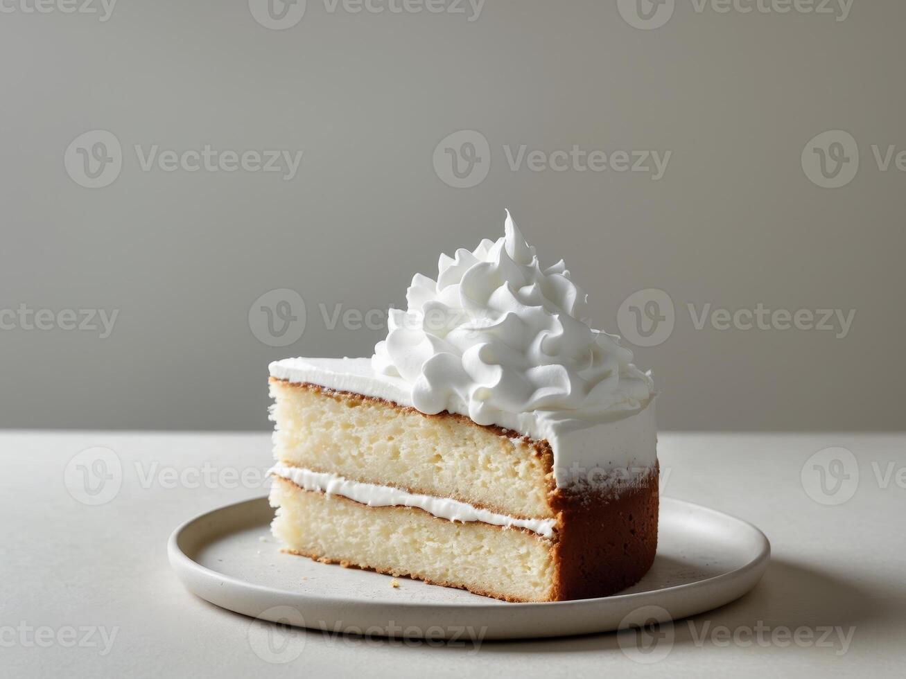 A slice of cake on a plate with whipped cream photo