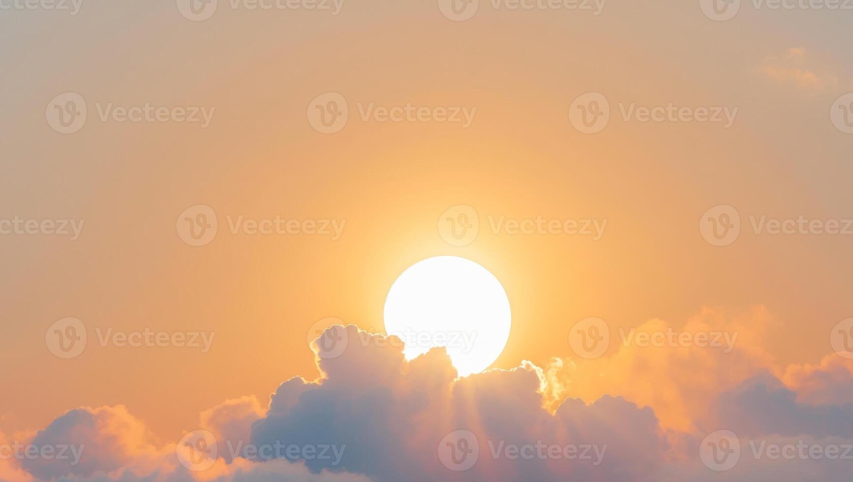 The sun is setting behind a cloud covered sky photo