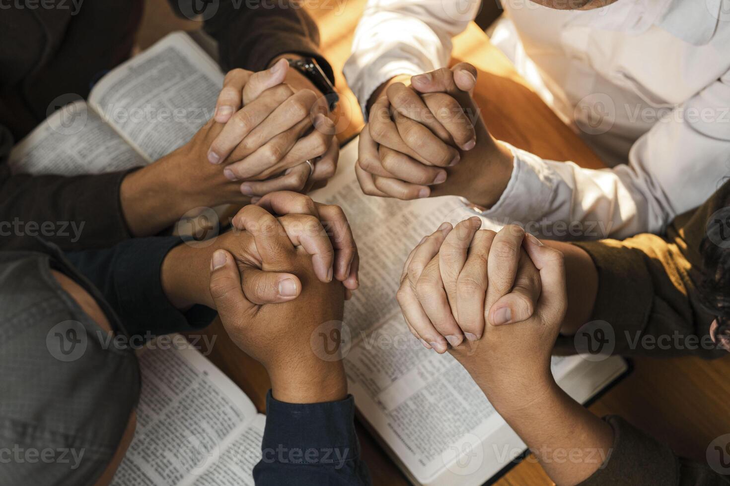 A group of young Christians working together to pray and seek blessings from God, the Bible, Christian ideas, sharing the gospel with each other. photo