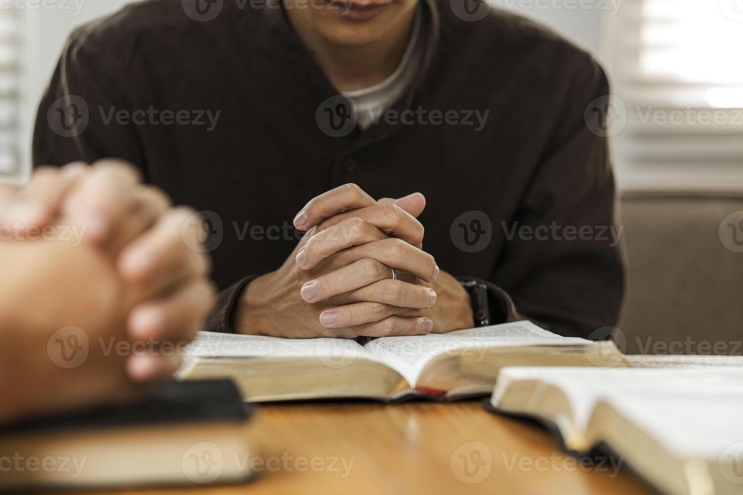 A group of young Christians working together to pray and seek blessings from God, the Bible, Christian ideas, sharing the gospel with each other. photo