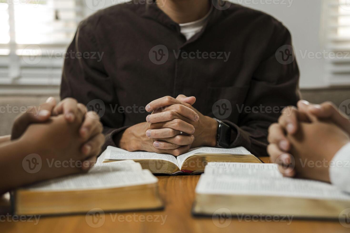 A group of young Christians working together to pray and seek blessings from God, the Bible, Christian ideas, sharing the gospel with each other. photo