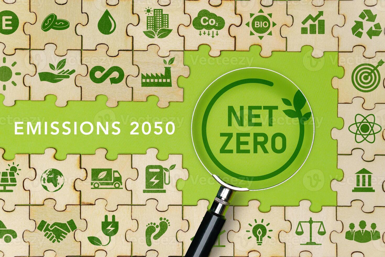 net zero and carbon neutral The green net zero icon on the Jigsaw and the net zero symbol on the magnifying glass. Ideas for a net-zero greenhouse gas emissions target Long term photo