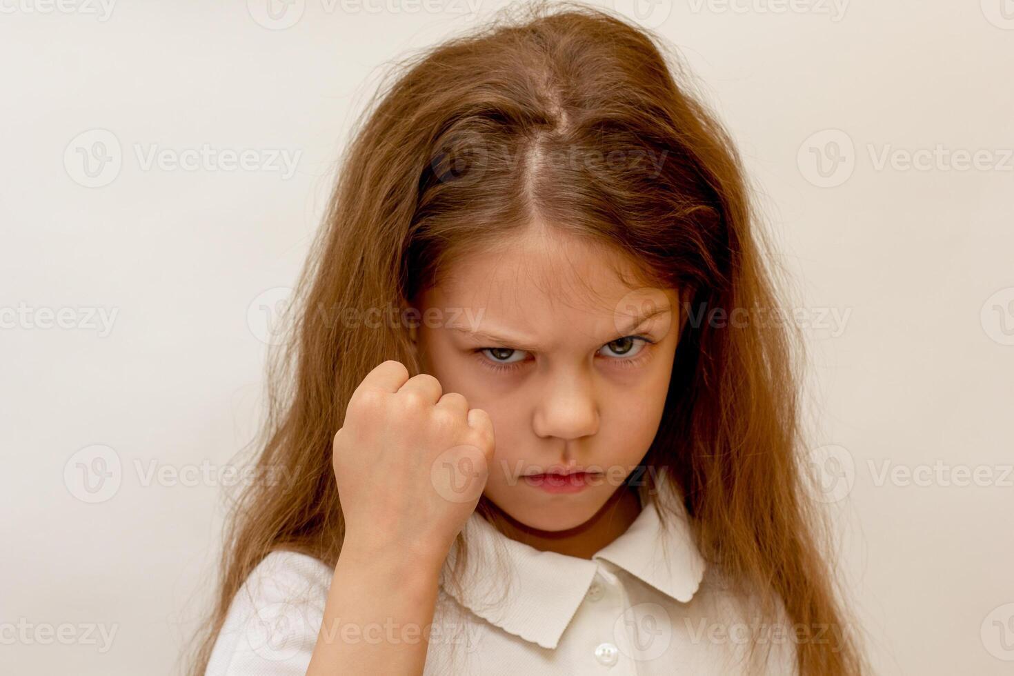 Portrait of caucasian child showing fist on white background photo