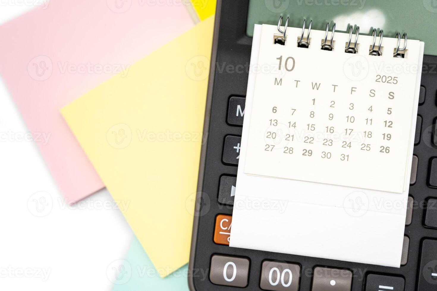 Simple desk calendar for OCTOBER 2025 on calculator. Calendar concept with copy space. 2025 OCT calendar. photo
