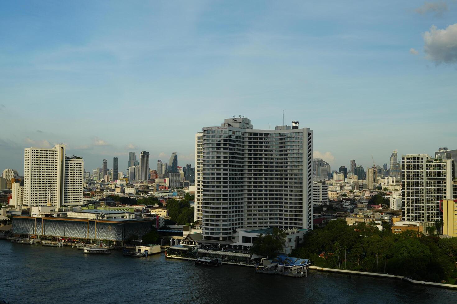 Bangkok, Thailand, 2024 - view of Bangkok building skyscrapers as seen from Chao Praya River, the famous river dissecting Bangkok. Photo taken from Icon Siam Bangkok overlooking Silom area.