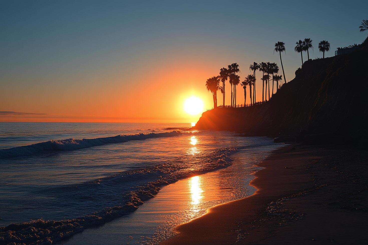 Beautiful sunset over ocean with palm trees lining the shore in a serene coastal location photo