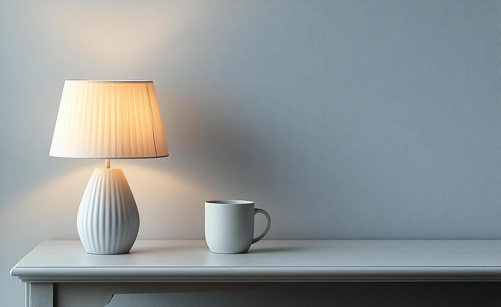 Elegant lamp and white mug on a wooden table against a soft gray wall photo