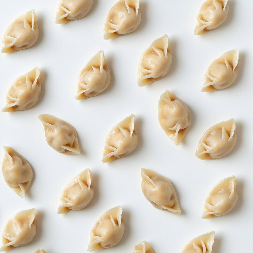 Dumplings arranged neatly on a white surface for culinary display and preparation in a kitchen setting photo