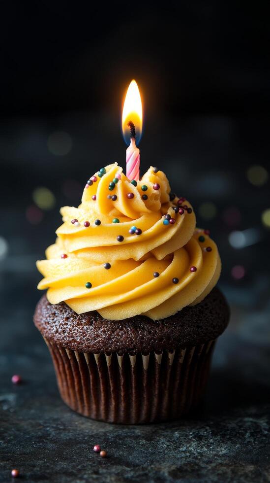 Celebrate with a bright cupcake topped with frosting and a candle for special occasions photo