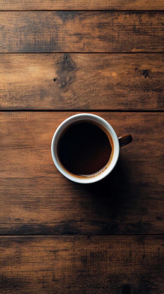 Coffee cup with brown liquid and coffee beans on wooden surface at cozy cafe photo