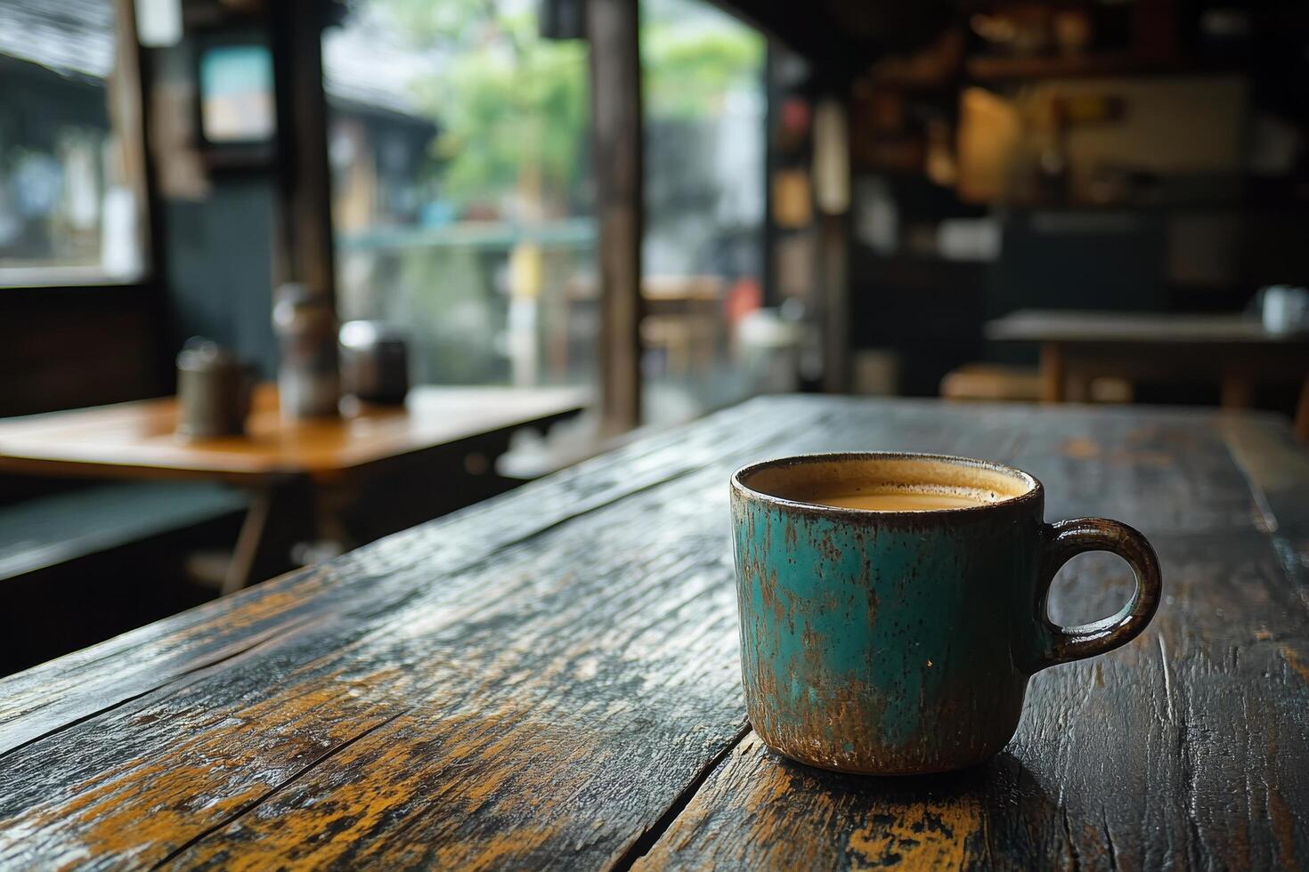 Warm latte served in a textured cup on a rustic wooden table in a cozy caf atmosphere photo