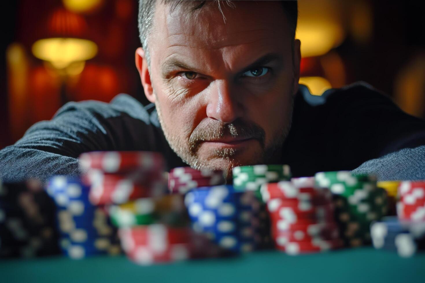 Intense poker player focuses on chips during a high-stakes game at a casino photo