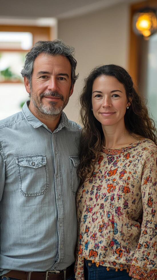 Couple poses together in a cozy indoor setting during a relaxed afternoon photo