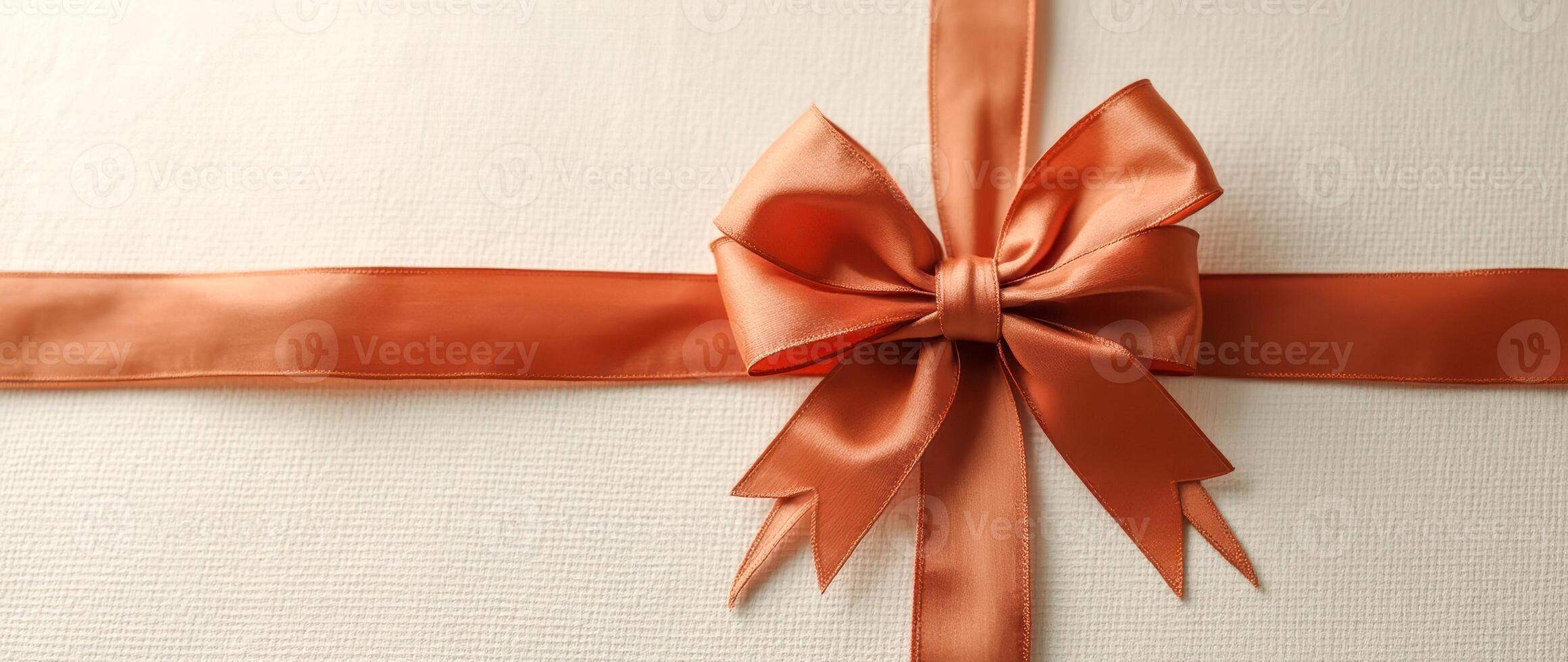 burnt satin ribbon bow on textured background photo