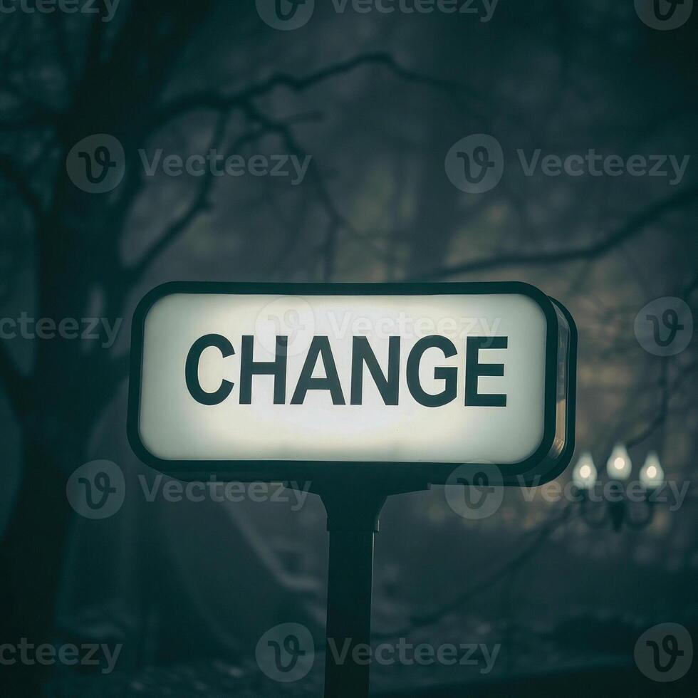 illuminated change sign a dark forest setting photo