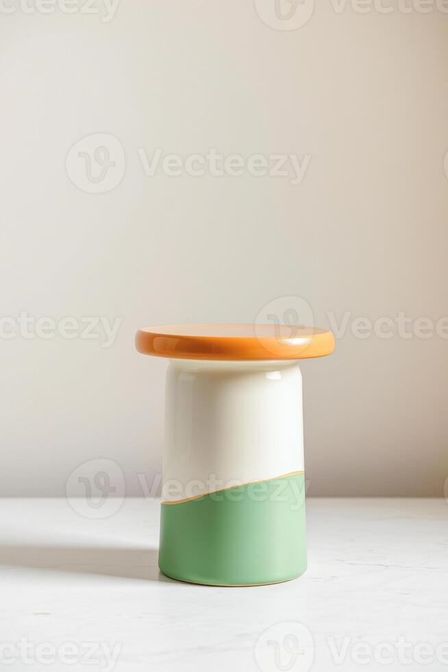 small cylindrical stool with a tri-color design. photo