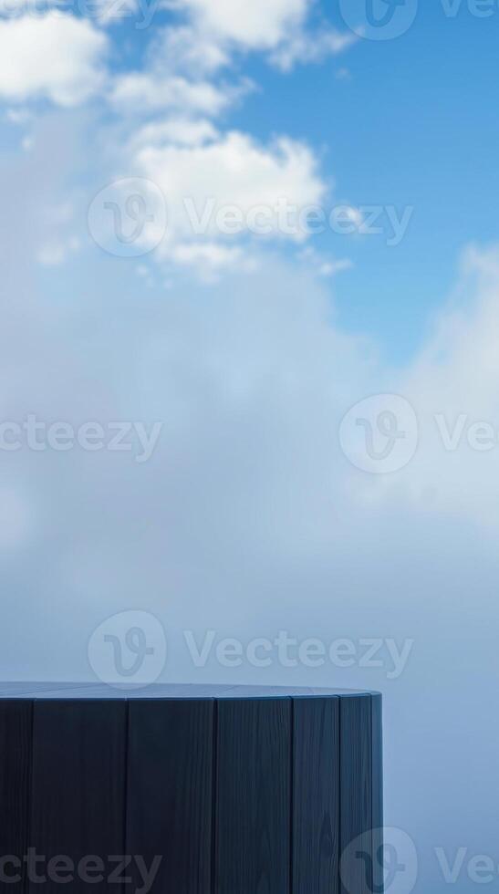 dark wooden pedestal against hazy sky photo
