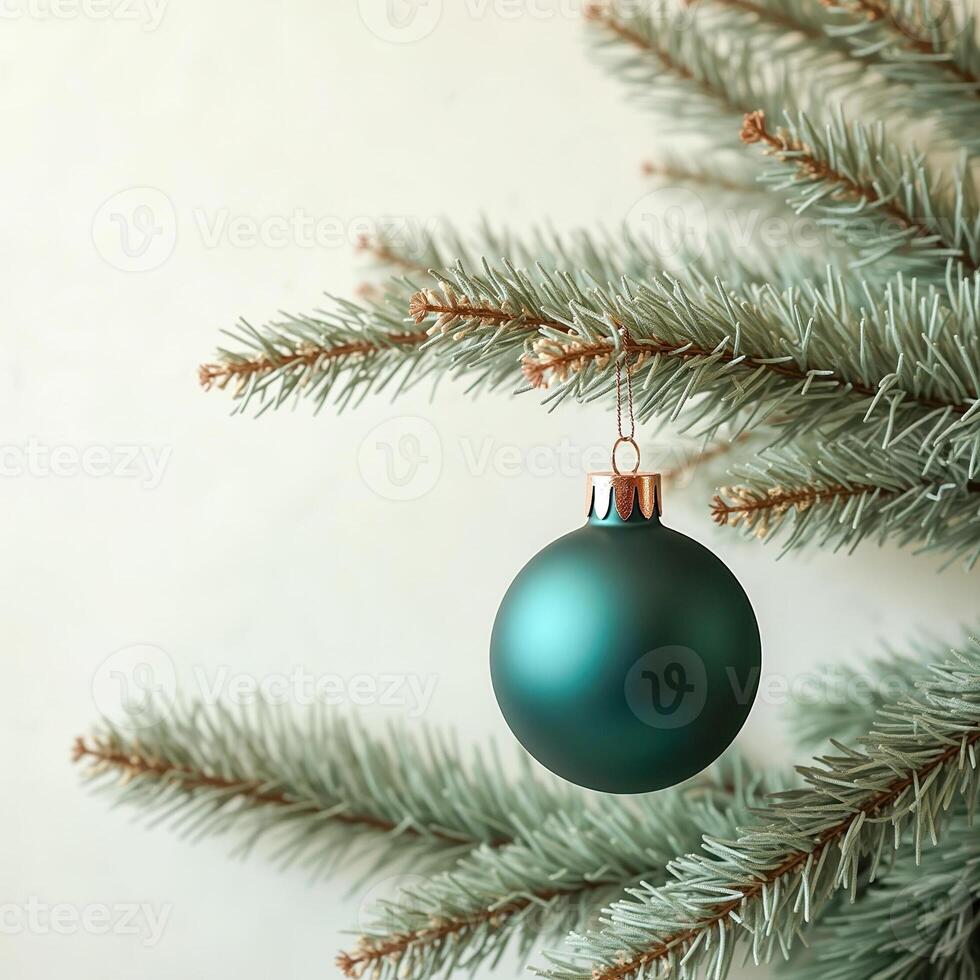 teal sphere ornament hanging from artificial evergreen tree branch photo