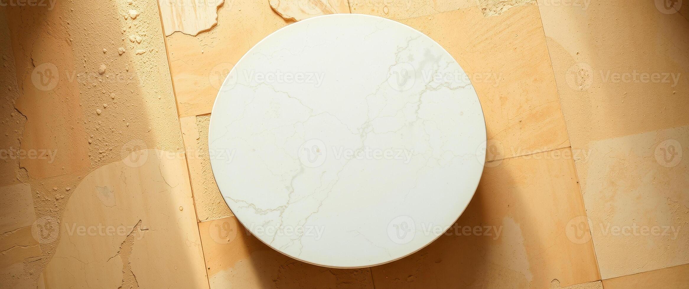 round marble table on textured yellow surface photo