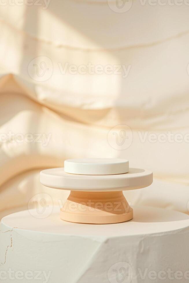creamy two-tiered cylindrical display stand on textured platform photo