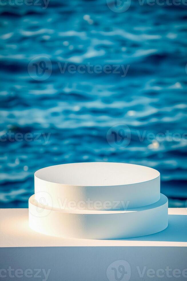 layered white cylindrical forms against blurred ocean photo