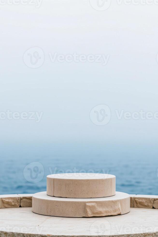two beige circular stone platforms by the ocean photo