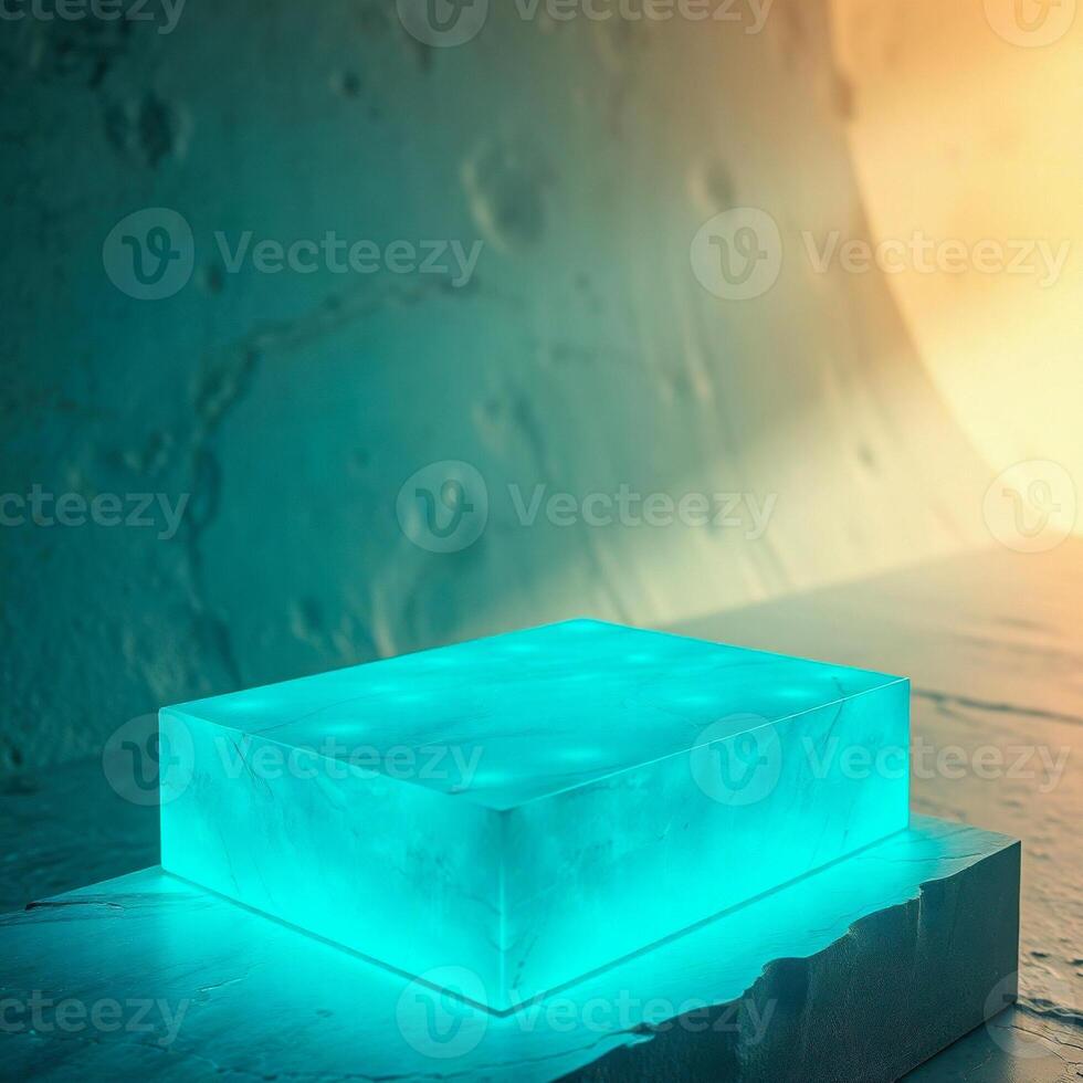illuminated cyan cube on stone base photo