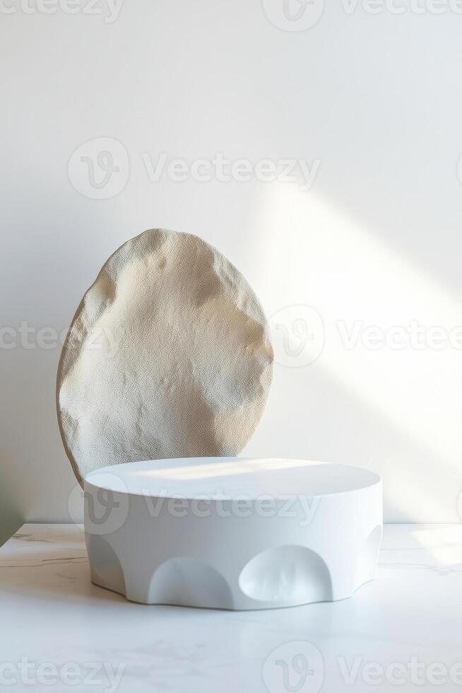 white pedestal with a textured circular form front it photo