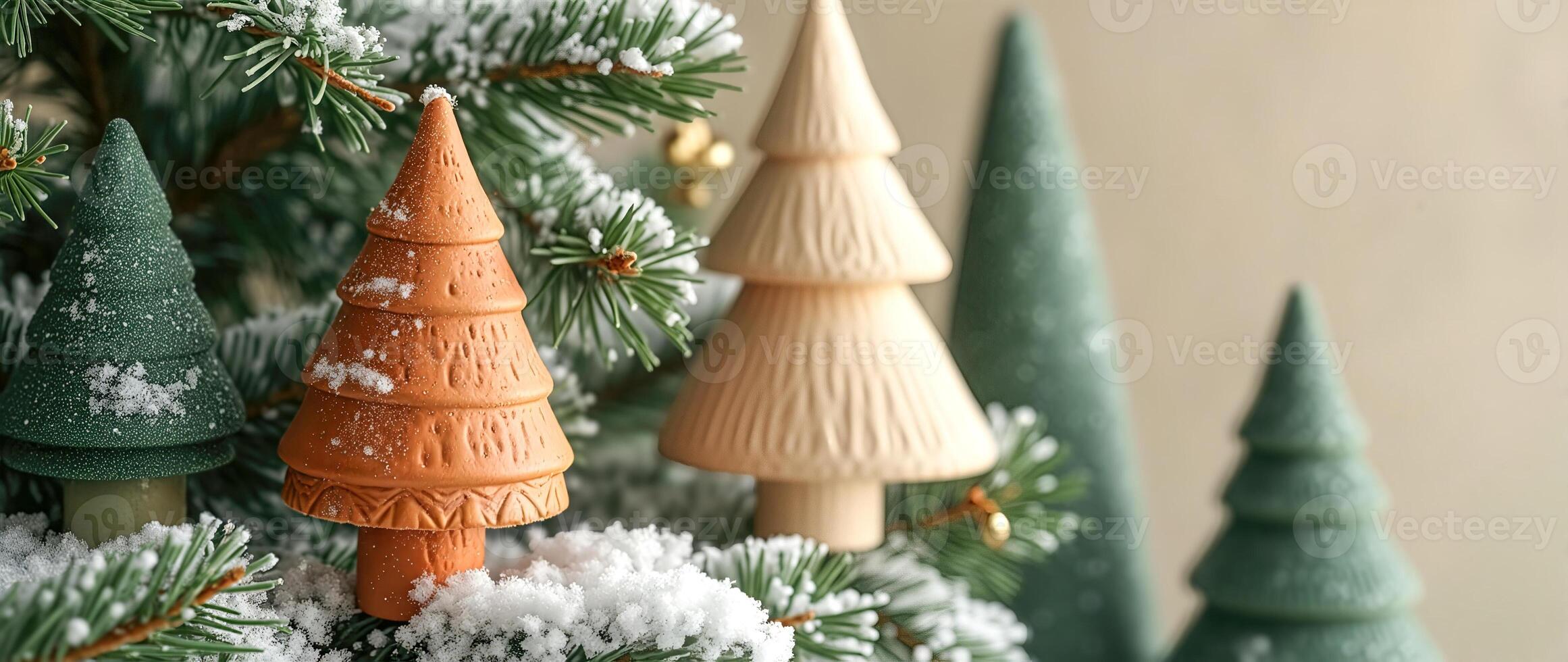 miniature ceramic trees decorate a snow-covered evergreen photo