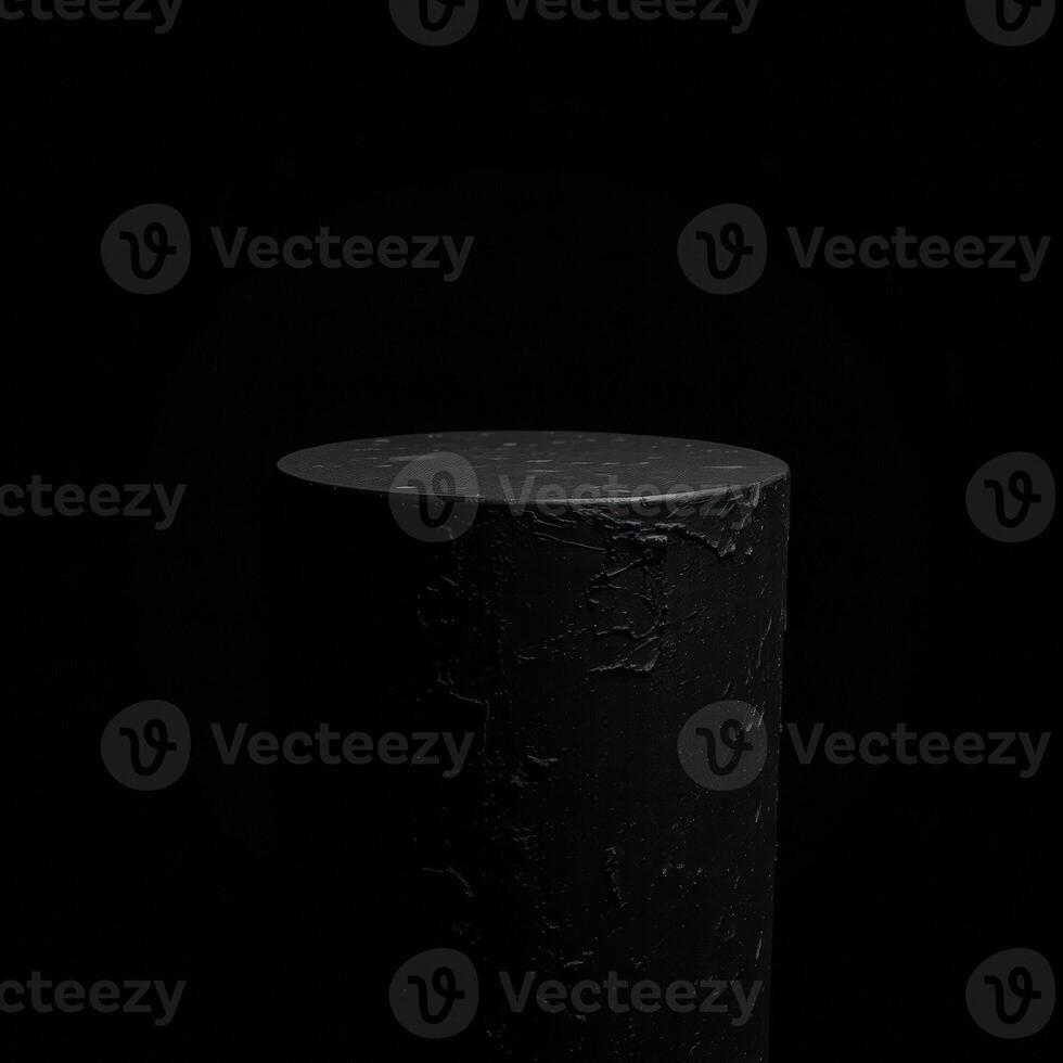 dark cylindrical pedestal on black background photo