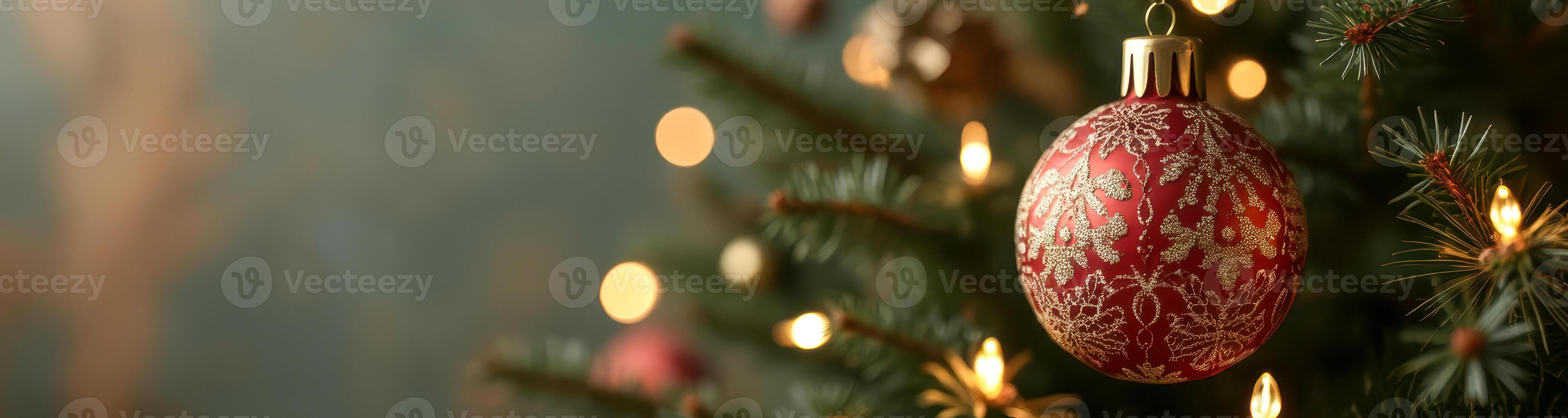 red glass ball ornament on illuminated tree branch photo