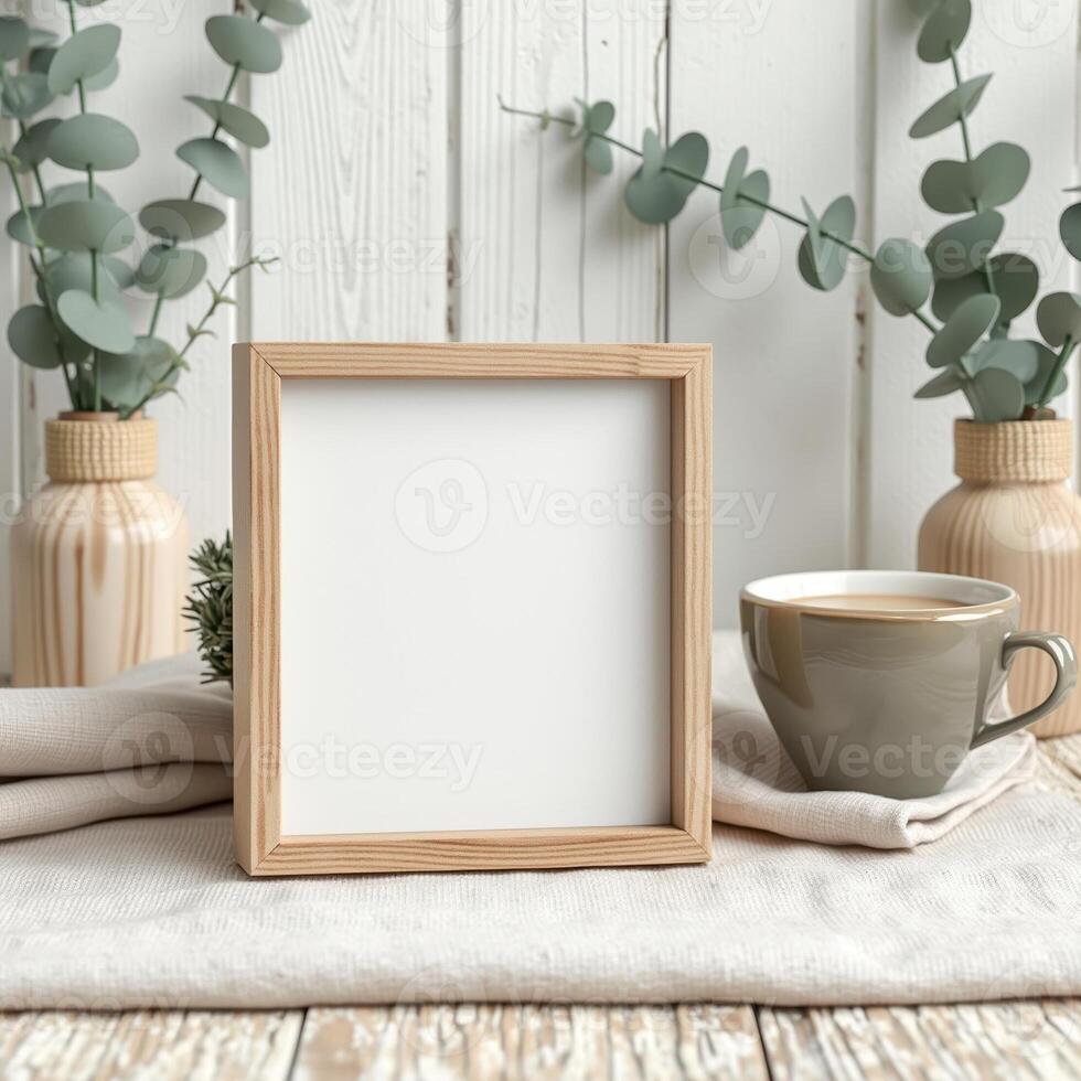 square wooden frame on neutral textile with eucalyptus coffee photo