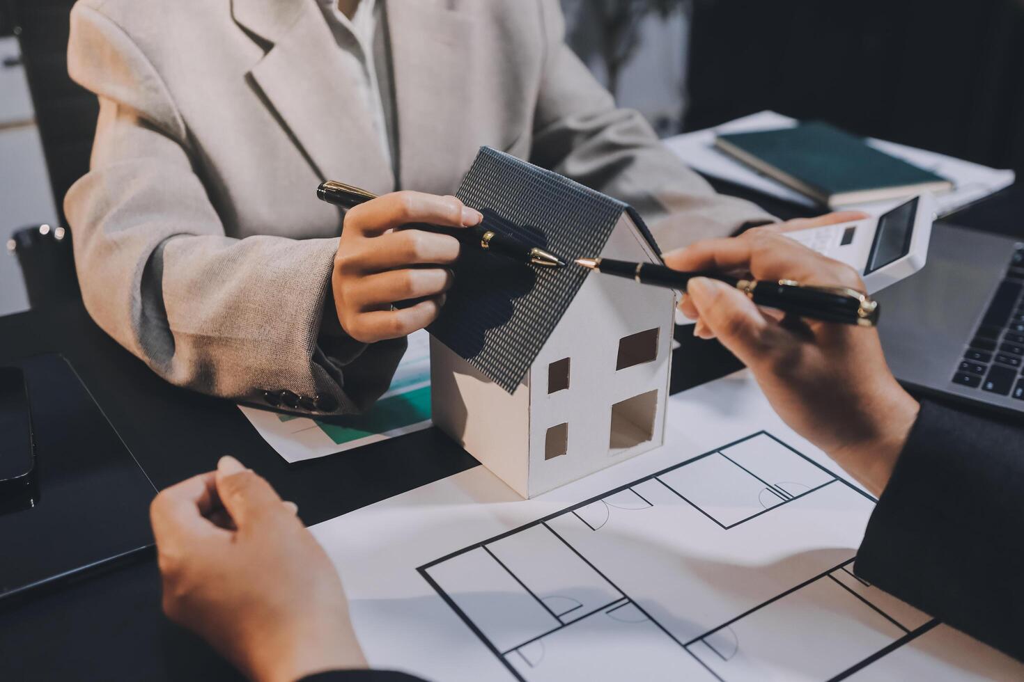 Close up Business people or Real Estate agent explain signing agreement for sale house to client. Property, Insurance, Broker concept. photo